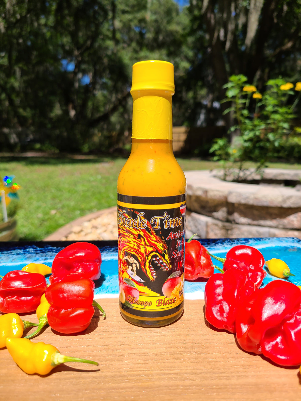 "Mango Blaze hot sauce bottle with mangoes and habanero peppers"