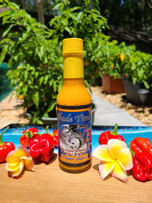 "Parrot Sauce hot sauce bottle with papaya, carrot, and basil"