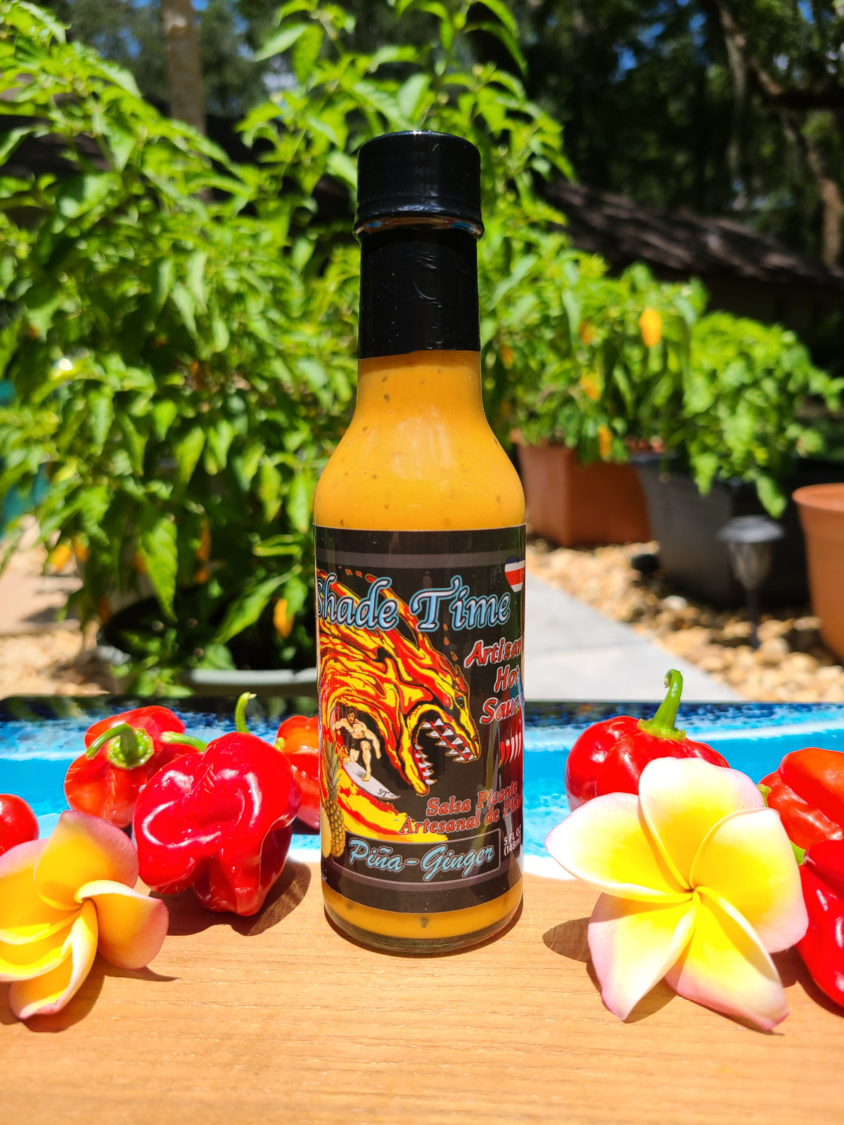 "Piña Ginger hot sauce bottle with pineapple and ginger root"