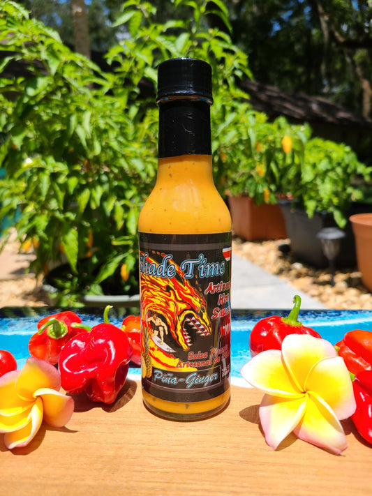 "Piña Ginger hot sauce bottle with pineapple and ginger root"